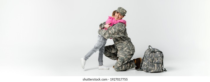 Happy Mother In Military Uniform Hugging Child Near Backpack On Grey Background, Banner  