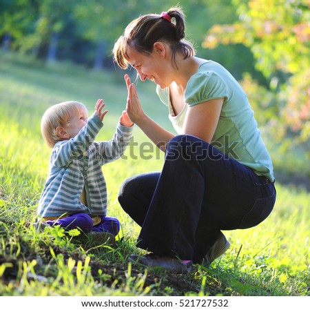 Similar – Mother playing with her daughter on the grass