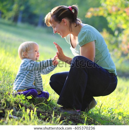 Similar – Mother playing with her daughter on the grass