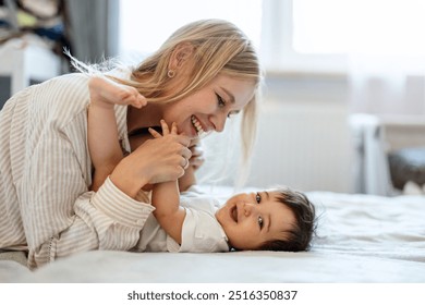 Happy mother playing with her baby daughter at home
 - Powered by Shutterstock