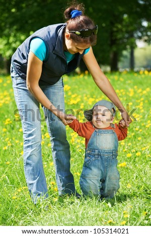 Similar – Mother playing with her daughter on the grass