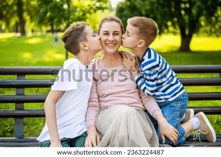 Similar – Image, Stock Photo Little boy kissing his mother on a field in summer