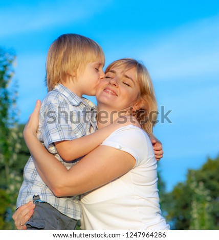 Similar – Image, Stock Photo Little boy kissing his mother on a field in summer