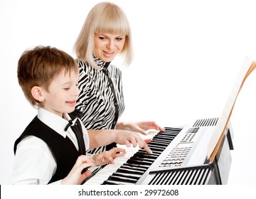 Happy Mother And Son Playing Electric Piano