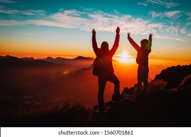 happy mother and son travel in mountains at sunset - Shutterstock ID 1560701861