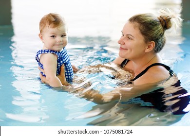 Happy Mother Swimming With Cute Adorable Baby Girl Daughter In Swimming Pool Spending Spa Vacations