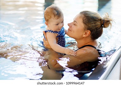 Happy Mother Swimming With Cute Adorable Baby Girl Daughter In Swimming Pool Spending Spa Vacations