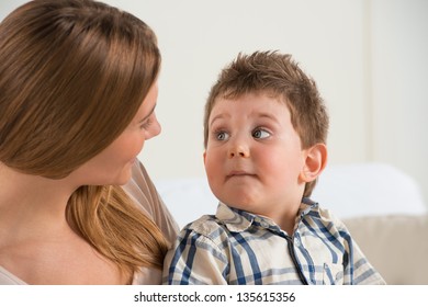 Happy Mother Talking To Her Son At Home