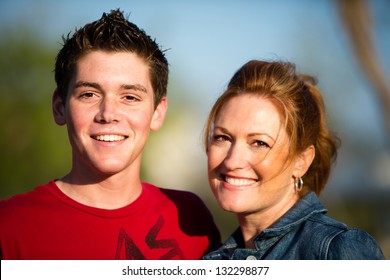 Happy Mother And Teen Son Smiling