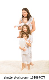 Happy Mother And Three Kids Standing On Carpet Home In A Line Isolated On White Background