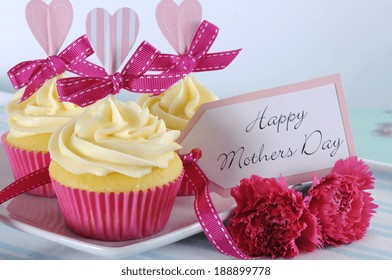 Happy Mothers Day aqua blue vintage retro shabby chic tray with pink cupcakes close up with pink hearts and ribbon decoration and gift tag - Powered by Shutterstock