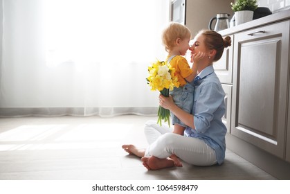 Happy Mother's Day! Baby Son Congratulates Mother On Holiday And Gives Flowers
