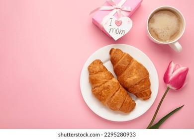 Happy mother's day, beautiful breakfast, lunch with cup of coffee, fresh croissants, tulip and gift. Spring holiday, family relations. Top view - Powered by Shutterstock