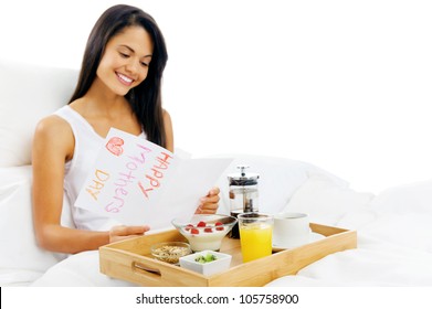 Happy Mothers Day Breakfast In Bed Mum Is Happy And Smiling, Reading A Card In The Morning