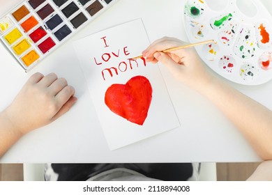 Happy Mothers Day. Child Girl Drawing Handmade Card For Mom For The Holiday With Watercolors. Top View