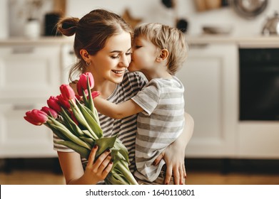 happy mother's day! child son congratulates mother on holiday and gives flowers - Shutterstock ID 1640110801