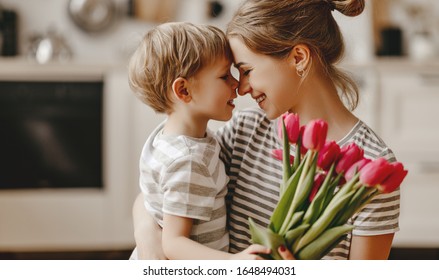 happy mother's day! child son congratulates mother on holiday and gives flowers - Shutterstock ID 1648494031