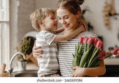 happy mother's day! child son congratulates mother on holiday and gives flowers - Shutterstock ID 1662659386