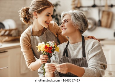 happy mother's day! family old grandmother mother-in-law and daughter-in-law daughter congratulate on the holiday, give flowers 