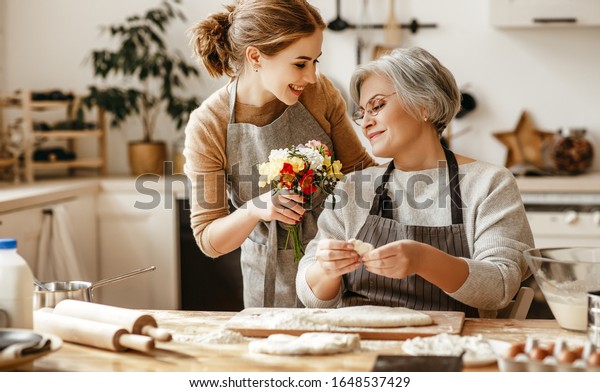 happy mother\'s day! family old grandmother\
mother-in-law and daughter-in-law daughter congratulate on the\
holiday, give flowers \
