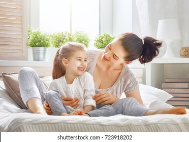 Happy mother's day! Mom and her daughter child girl are playing, smiling and hugging. Family holiday and togetherness. - Shutterstock ID 723918202