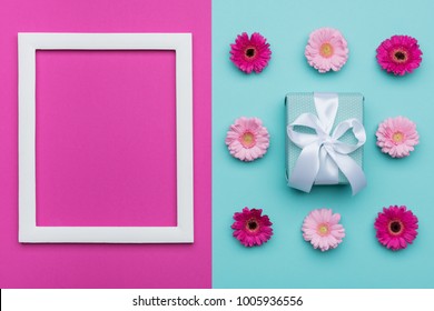 Happy Mother's Day, Women's Day, Valentine's Day or Birthday Pastel Blue and Pink Candy Colour Background. Floral flat lay minimal concept with beautifully wrapped present.