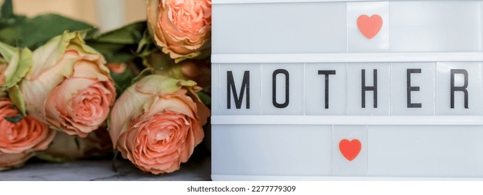 Happy Mother's Day.Lightbox with the word Happy Mother's Day next to flowers. Holiday card. - Shutterstock ID 2277779309