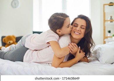 Happy mother's day.Portrait of happy mother and daughter lying on the bed at home. - Shutterstock ID 1714638649