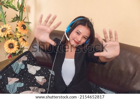 A happy and motivated customer service representative working remotely at her living room. A call center employee with work from home arrangement.