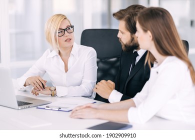 Happy Motivated Diverse Business People Work Together, Collaborate In An Office Meeting, Colleagues Discuss Financial Project Ideas In A Boardroom Briefing.