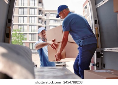 Happy movers loading truck with items from move - Powered by Shutterstock