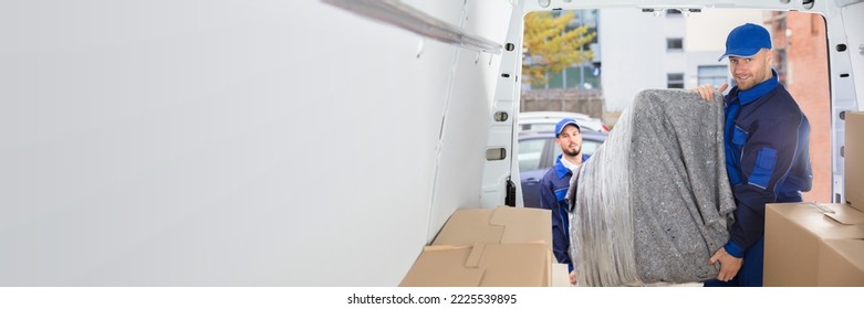 Happy Movers Unloading Furniture From Truck. Mover Service