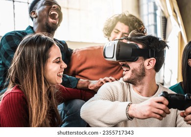 Happy multi ethnic friends sitting on sofa playing video games with VR 3d viewer at home - Cheerful generation z group having fun with modern technology videogames - Hobby and tech concept