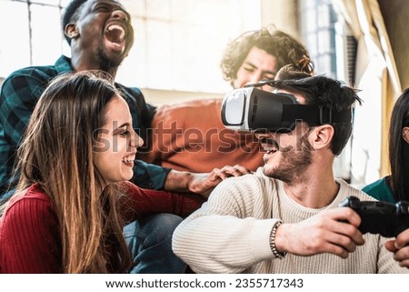 Happy multi ethnic friends sitting on sofa playing video games with VR 3d viewer at home - Cheerful generation z group having fun with modern technology videogames - Hobby and tech concept