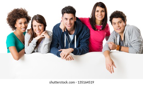 Happy Multi Ethnic Group Of Friends Showing Blank Billboard Isolated On White Background