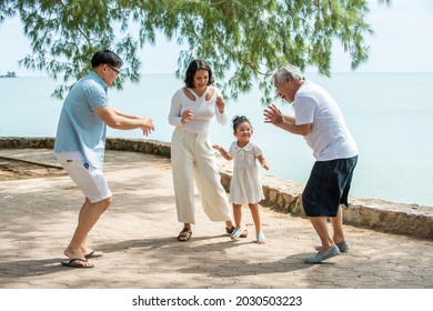 Happy Multi Generation Asian Family Enjoy Picnic Travel Together On The Beach In Summer. Parents With Retired Senior Grandparent And Cute Child Girl Relax And Having Fun On Summer Holiday Vacation