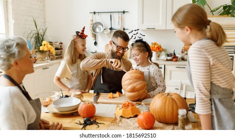 Happy multi generational family smiling and carving jack o lantern from pumpkin while gathering around table during Halloween celebration
 - Powered by Shutterstock