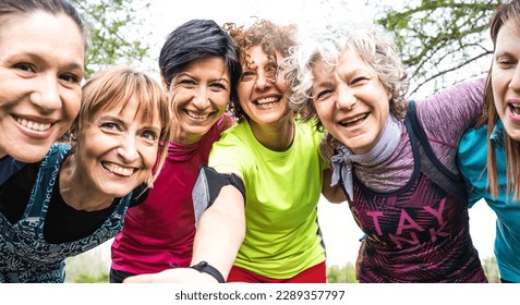 Happy multi generational women having fun together at city park - Multigenerational female friends taking selfie after sport workout outdoor - Bright filter with focus on faces - Powered by Shutterstock