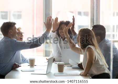 Happy multicultural executive team people give high five, diverse motivated office employees group engaged in teambuilding spirit promise trust integrity celebrate shared business success win concept