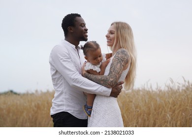 Happy Multicultural Family Of Father Mother And Daughter