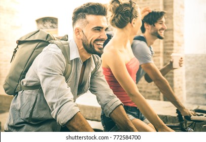 Happy Multicultural Friends Having Fun Riding Bicycle In City Old Town - Friendship Concept With Young People Students Biking Together To University College Campus - Bright Vintage Retro Filter