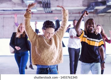 happy multiethnic business team dancing during moving in at new unfinished startup office building - Powered by Shutterstock