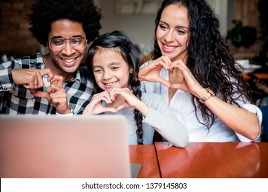 Happy Multiethnic Family Having Fun While Using Laptop Together, Video Chat Concept