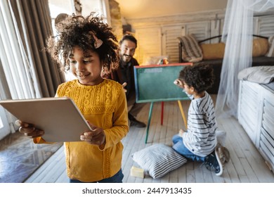 Happy multiethnic family. Single father having fun together at home with african american children. - Powered by Shutterstock