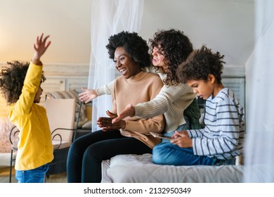 Happy Multiethnic Family. Smiling Gay Women Couple Spending Time Together With Children At Home.