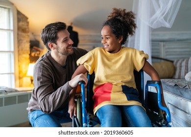 Happy Multiethnic Family. Smiling Little Girl With Disability In Wheelchair