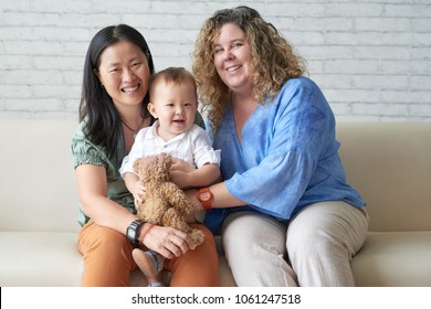 Happy Multi-ethnic Female Couple With Their Adorable Baby Boy