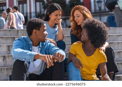 Happy multiethnic friends sitting on stairs in the city having fun, young handsome models - Shutterstock ID 2275696073