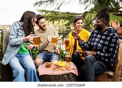 Happy Multiethnic Friends Talking, Clinking And Toasting Beer At Brewery Bar Restaurant Patio - Life Style And Beverage Concept With Young People Having Fun Together Out Side