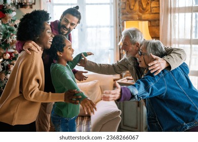 Happy multiethnic multi-generational family enjoying Christmas time together. People love concept. - Powered by Shutterstock